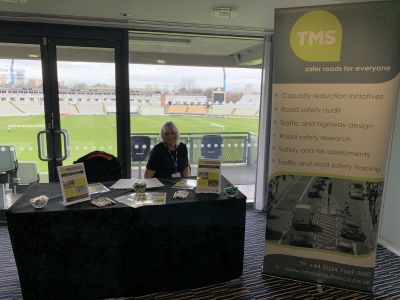 Woman sitting behind a table at TMS road safety conference
